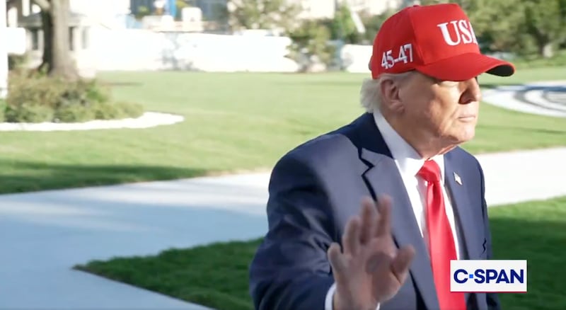 Donald Trump gestures towards a reporter at the White House.