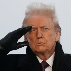 U.S. President Donald Trump salutes during a dignified transfer of the remains of two Iowa National Guard members at Dover Air Force Base in Dover, Delaware, U.S., December, 17, 2025.