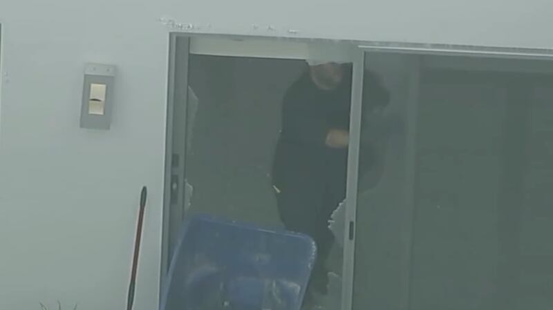 Footage of the home's broken glass door.
