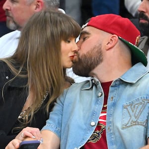CLEVELAND, OHIO - MAY 23: (L-R) Singer Taylor Swift and Travis Kelce of the Kansas City Chiefs kiss during Game Three between the New York Knicks and the Cleveland Cavaliers in the NBA Eastern Conference Finals at Rocket Arena on May 23, 2026 in Cleveland, Ohio. NOTE TO USER: User expressly acknowledges and agrees that, by downloading and or using this photograph, User is consenting to the terms and conditions of the Getty Images License Agreement. (Photo by Jason Miller/Getty Images)