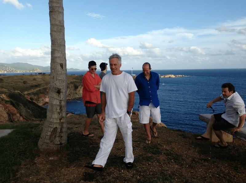 An undated photo of Jeffrey Epstein and Howard Lutnick (in blue shirt) on Epstein's island in the Caribbean.