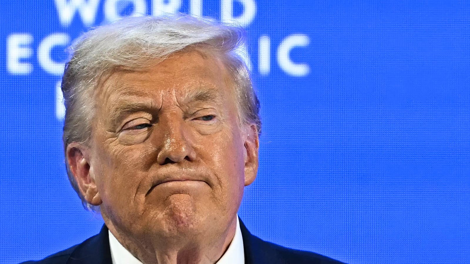 TOPSHOT - US President Donald Trump looks on during the World Economic Forum (WEF) annual meeting in Davos on January 21, 2026. The World Economic Forum takes place in Davos from January 19 to January 23, 2026. (Photo by Fabrice COFFRINI / AFP via Getty Images)