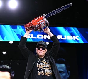 Elon Musk holds a chainsaw reading "Long live freedom, damn it" during the annual Conservative Political Action Conference (CPAC) at the Gaylord National Resort & Convention Center at National Harbor in Oxon Hill, Maryland, on February 20, 2025. The chainsaw was a present to Elon Musk from Argentina's President Javier Milei. (Photo by SAUL LOEB / AFP)
