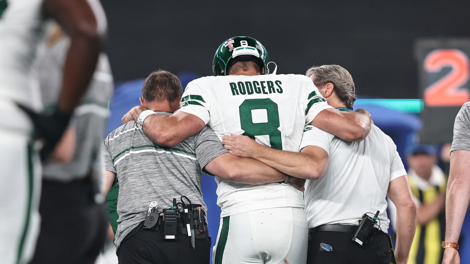 Aaron Rodgers #8 of the New York Jets is helped off the field.