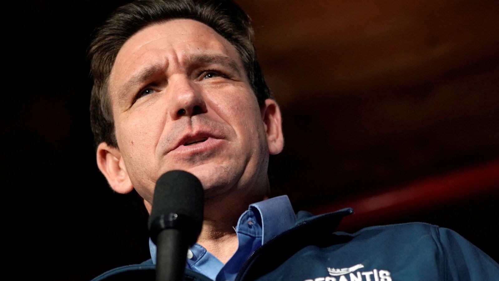 Ron DeSantis speaks at an Iowa campaign event with a microphone in hand.