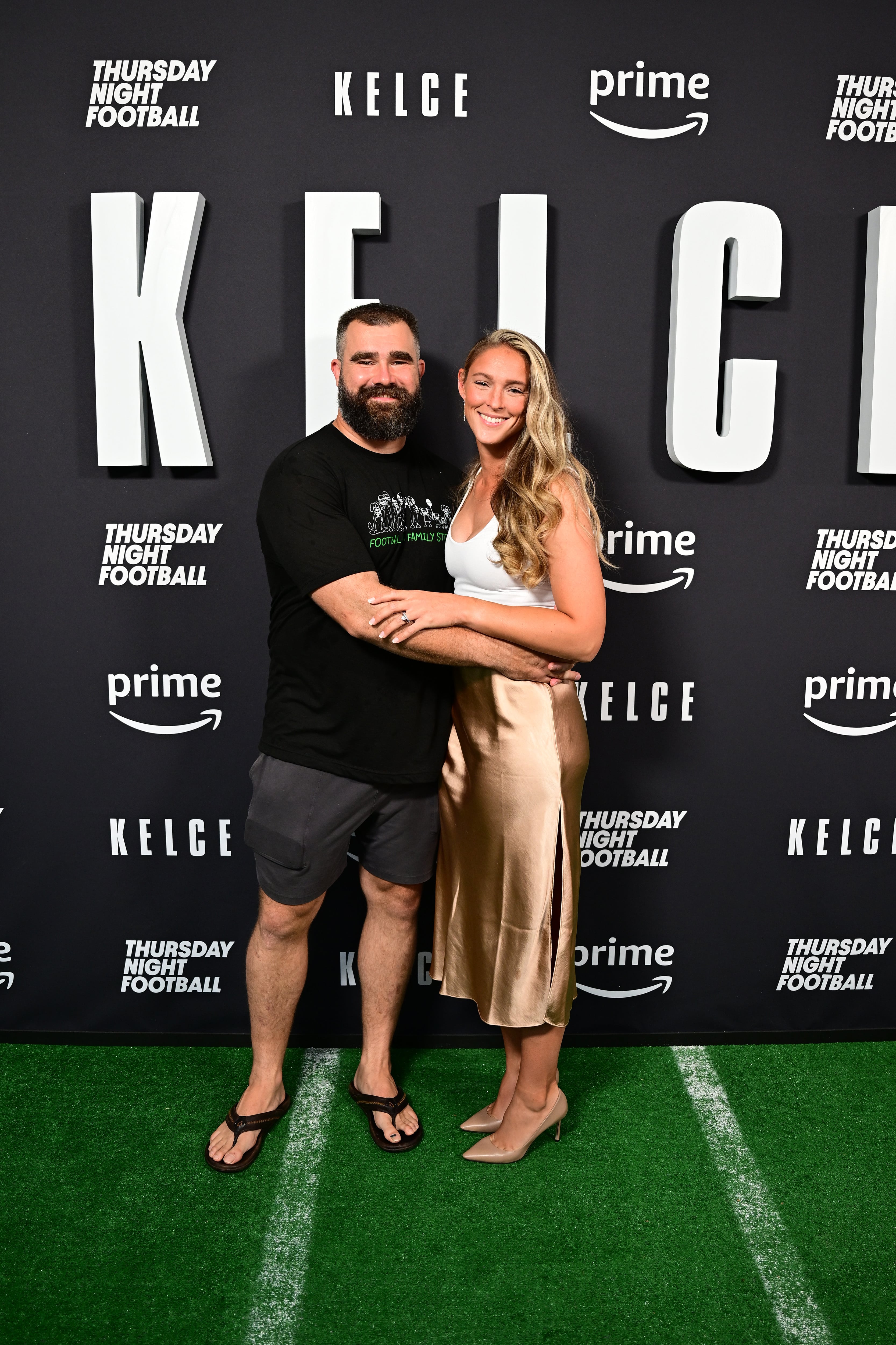 Jason Kelce famously loves flip-flops. Pictured with wife Kylie Kelce at the screening of his documentary 'Kelce' in Philadelphia in 2023.