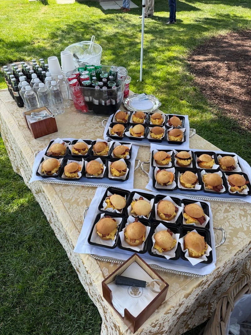 Breakfast sandwiches and soft drinks on table at White House.