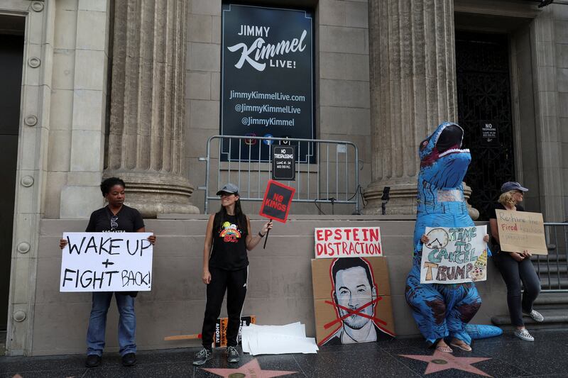 Demonstrators display signs as they protest in support of Jimmy Kimmel