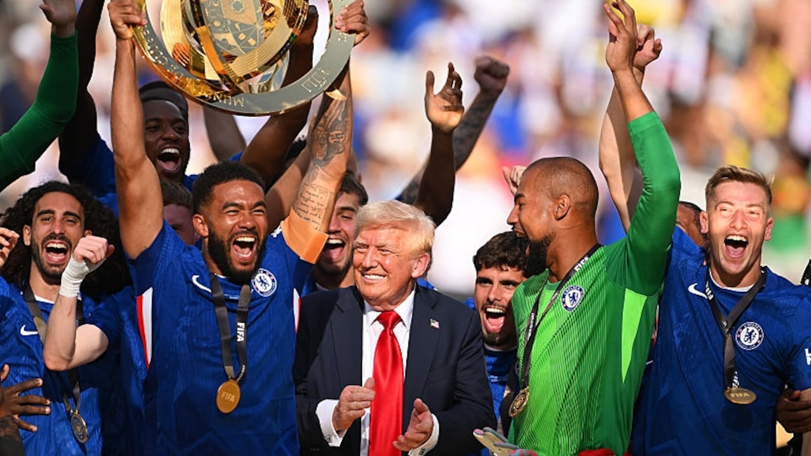 Reece James #24 of Chelsea FC lifts the FIFA Club World Cup trophy after their team's victory as U.S. President Donald Trump reacts following the FIFA Club World Cup 2025 Final match between Chelsea FC and Paris Saint-Germain at MetLife Stadium on July 13, 2025 in East Rutherford, New Jersey.