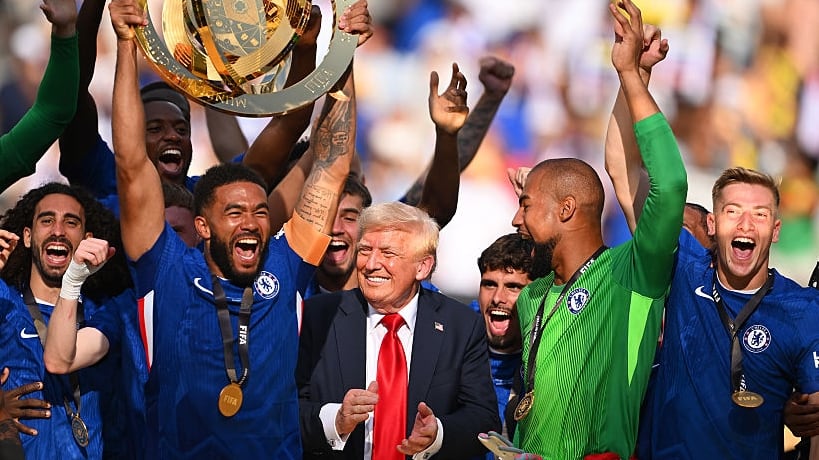 Reece James #24 of Chelsea FC lifts the FIFA Club World Cup trophy after their team's victory as U.S. President Donald Trump reacts following the FIFA Club World Cup 2025 Final match between Chelsea FC and Paris Saint-Germain at MetLife Stadium on July 13, 2025 in East Rutherford, New Jersey.