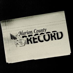 Photo illustration of a beige newspaper with the Marion County Record logo distorted on top with distressed texture on a black background