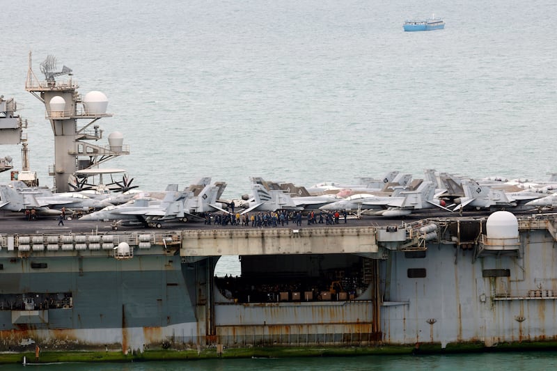 Sailors gather next to jet fighters on the US Navy nuclear-powered aircraft carrier USS Abraham Lincoln (CVN-72) before docking at the Laem Chabang deep-sea port in Laem Chabang, Chonburi province, Thailand, 02 September 2026. The Nimitz-class nuclear-powered aircraft carrier USS Abraham Lincoln, with roughly 5,000 sailors and Marines aboard and other vessels from its Carrier Strike Group, is docked with personnel to come ashore in Thailand from 02 to 06 September 2026, to rest and recuperate while the warship replenishes supplies after an extended deployment for operations in the Middle East.
