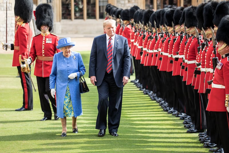 WINDSOR, ENGLAND - JULY 13:  U.S. President Donald Trump and Britain's Queen Elizabeth II inspect a Guard of Honour, formed of the Coldstream Guards at Windsor Castle on July 13, 2018 in Windsor, England.  Her Majesty welcomed the President and Mrs Trump at the dais in the Quadrangle of the Castle. A Guard of Honour, formed of the Coldstream Guards, gave a Royal Salute and the US National Anthem was played. The Queen and the President inspected the Guard of Honour before watching the military march past. The President and First Lady then joined Her Majesty for tea at the Castle.  (Photo by Richard Pohle  - WPA Pool/Getty Images)