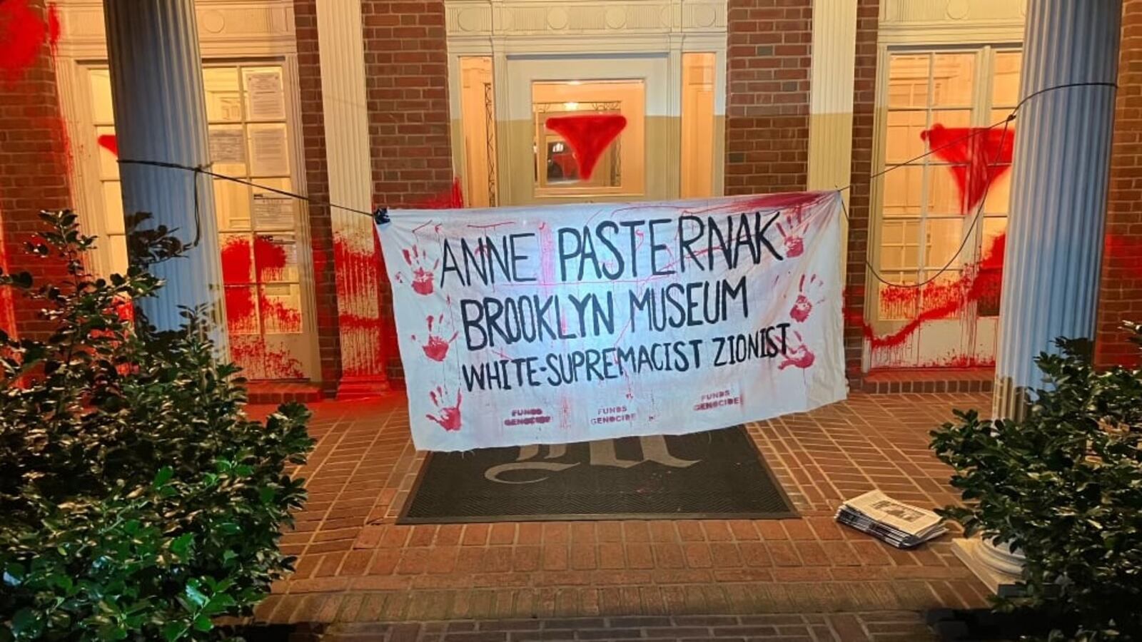 A banner hangs outside the home of Brooklyn Museum director Anne Pasternak.