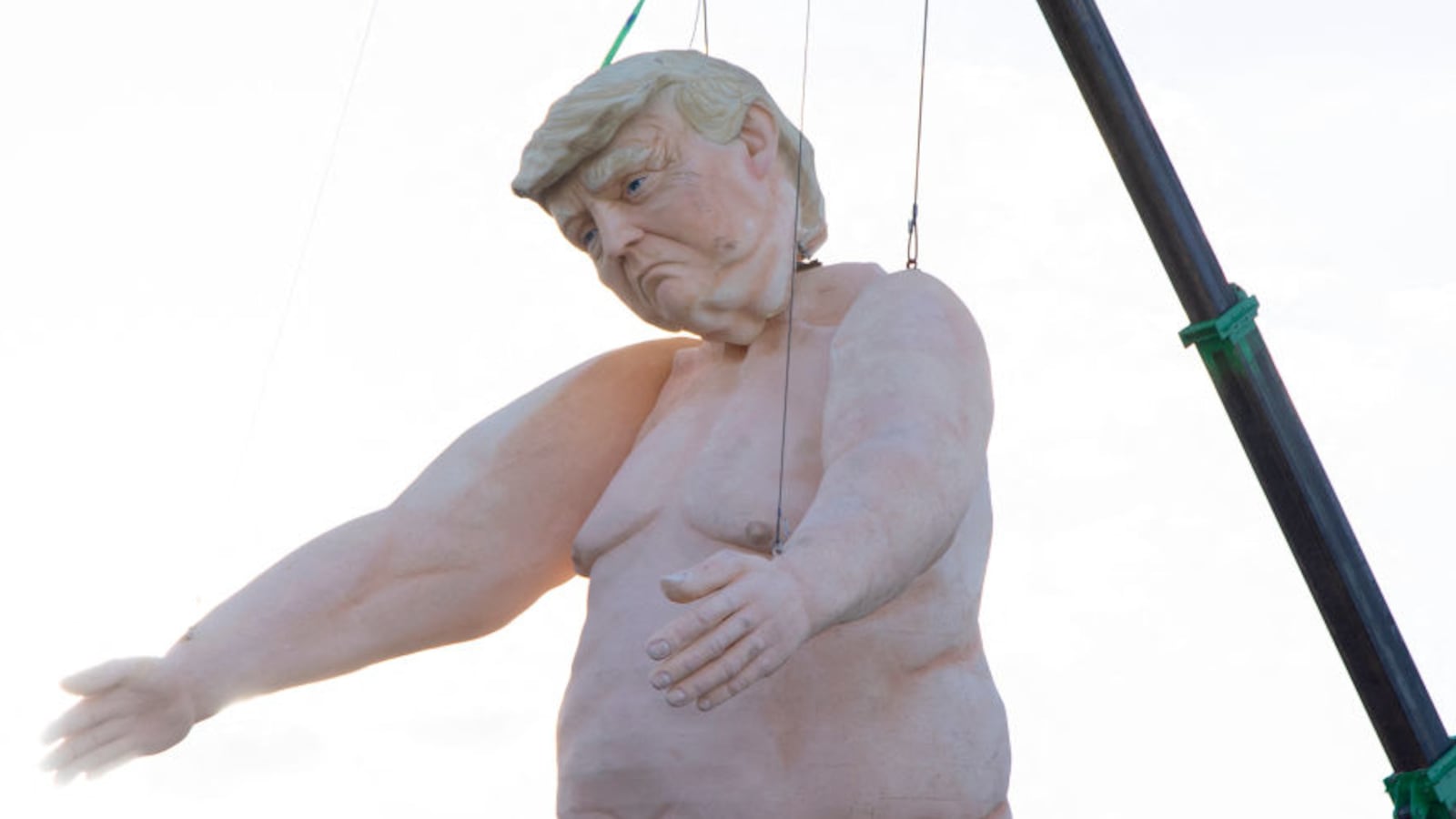 A 43-foot-tall naked statue resembling Donald Trump is displayed in a fenced-in lot near Interstate 15 north of Las Vegas, Nevada.
