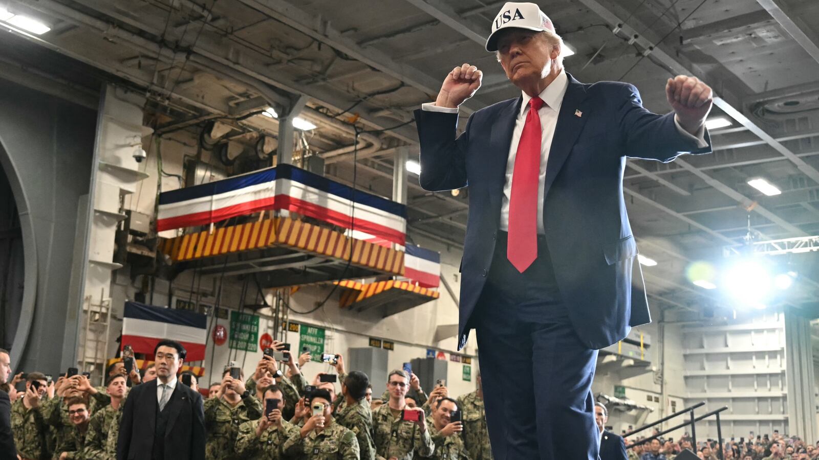 US President Donald Trump dances as he leaves after delivering a speech in front of US Navy personnel on board the US Navy's USS George Washington aircraft carrier at the US naval base in Yokosuka on October 28, 2025
