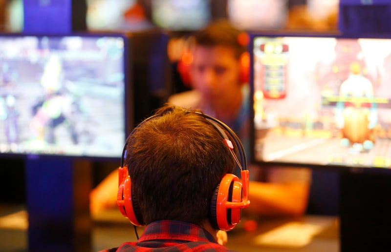 Visitors play "Warcraft", developed by video game producer Blizzard Entertainment, during the Gamescom fair in Cologne, Germany August 5, 2015. The Gamescom convention, Europe's largest video games trade fair, runs from August 5 to August 9. REUTERS/Kai Pfaffenbach