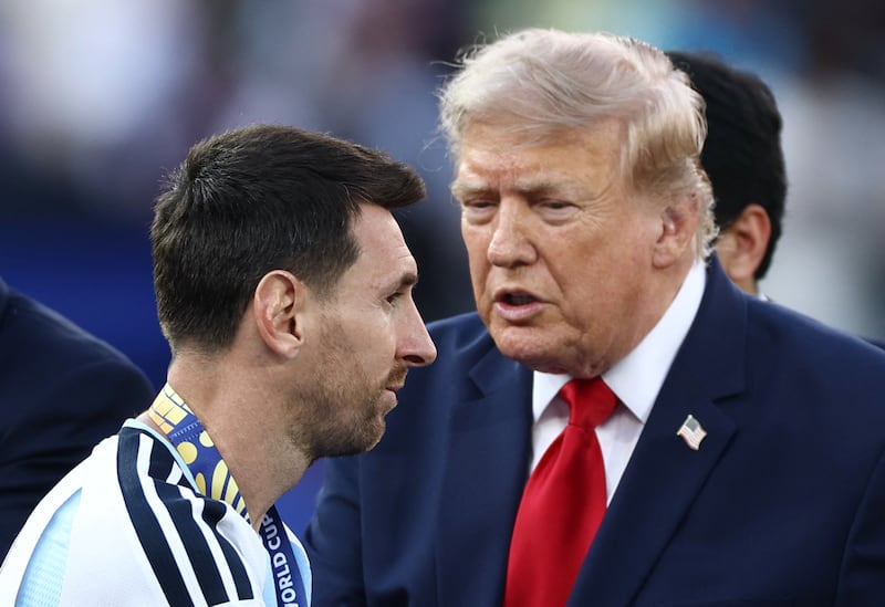 Soccer Football - FIFA World Cup 2026 - Final - Spain v Argentina - New York/New Jersey Stadium, East Rutherford, New Jersey, U.S. - July 19, 2026 Argentina's Lionel Messi collects his runners-up medal during the trophy ceremony as U.S. President Donald Trump looks on REUTERS/Lee Smith