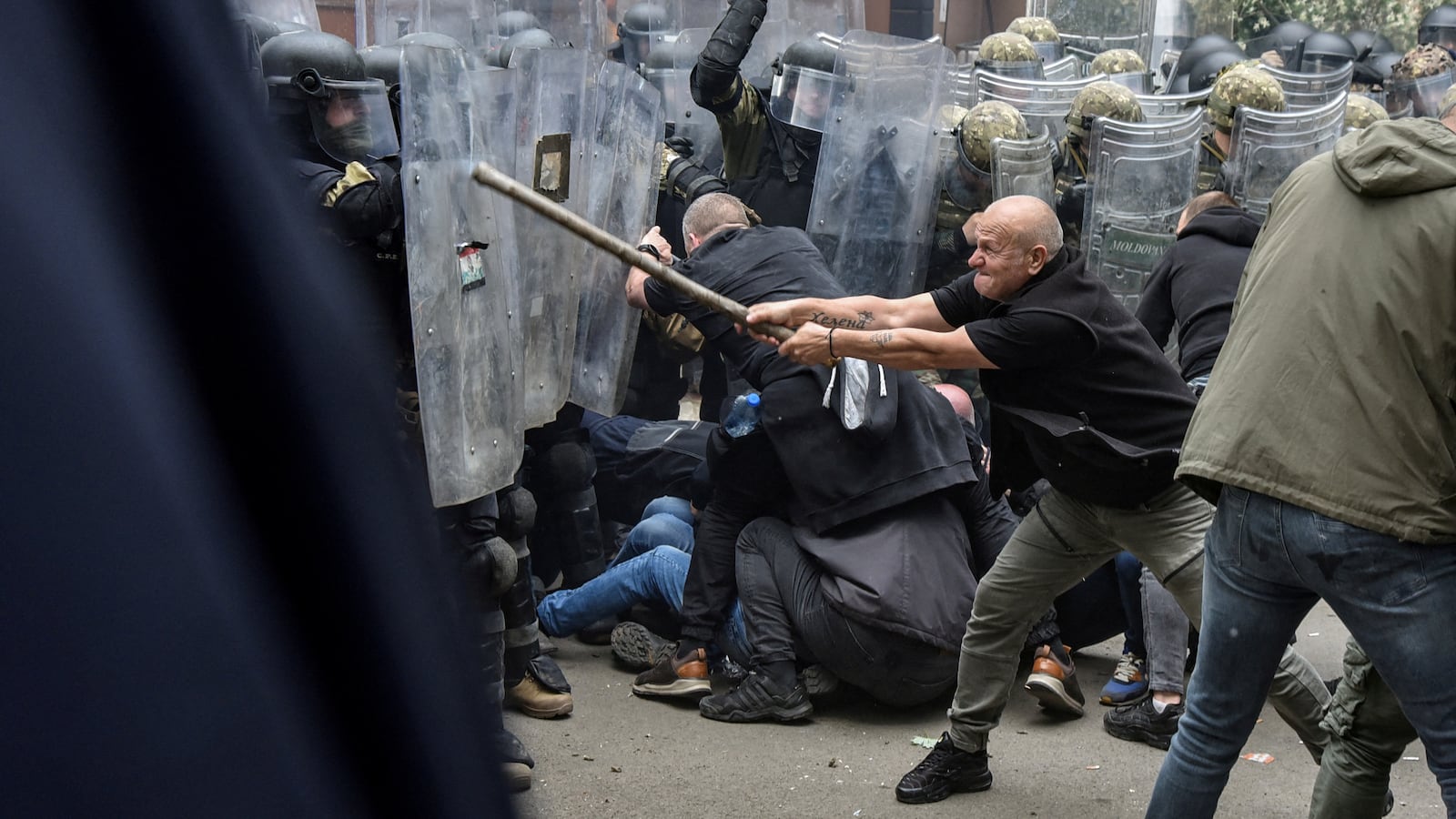 Approximately two dozen peacekeeping soldiers were injured in Kosovo on Monday by Serb protesters, officials say.