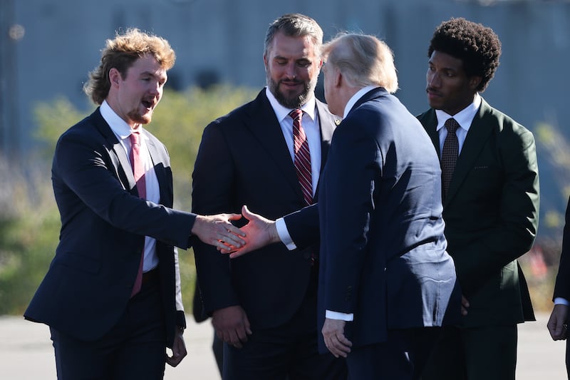 Trump shakes Eckley's hand as Moore and Humphrey look on.