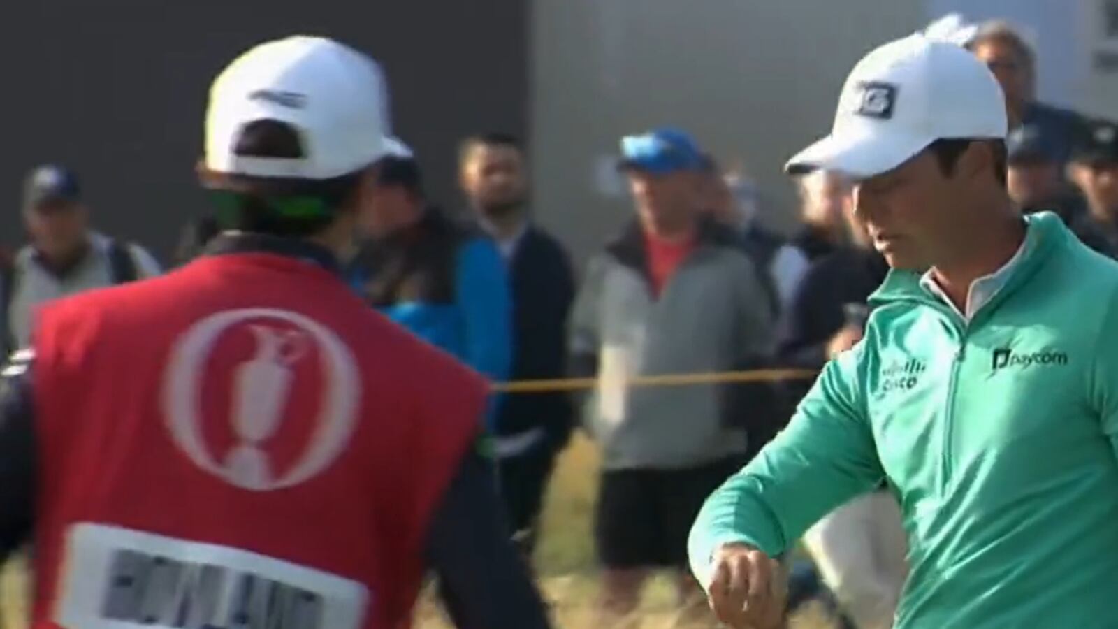 Viktor Hovland examines his arm after a bird pooped on him at the Open Championship.