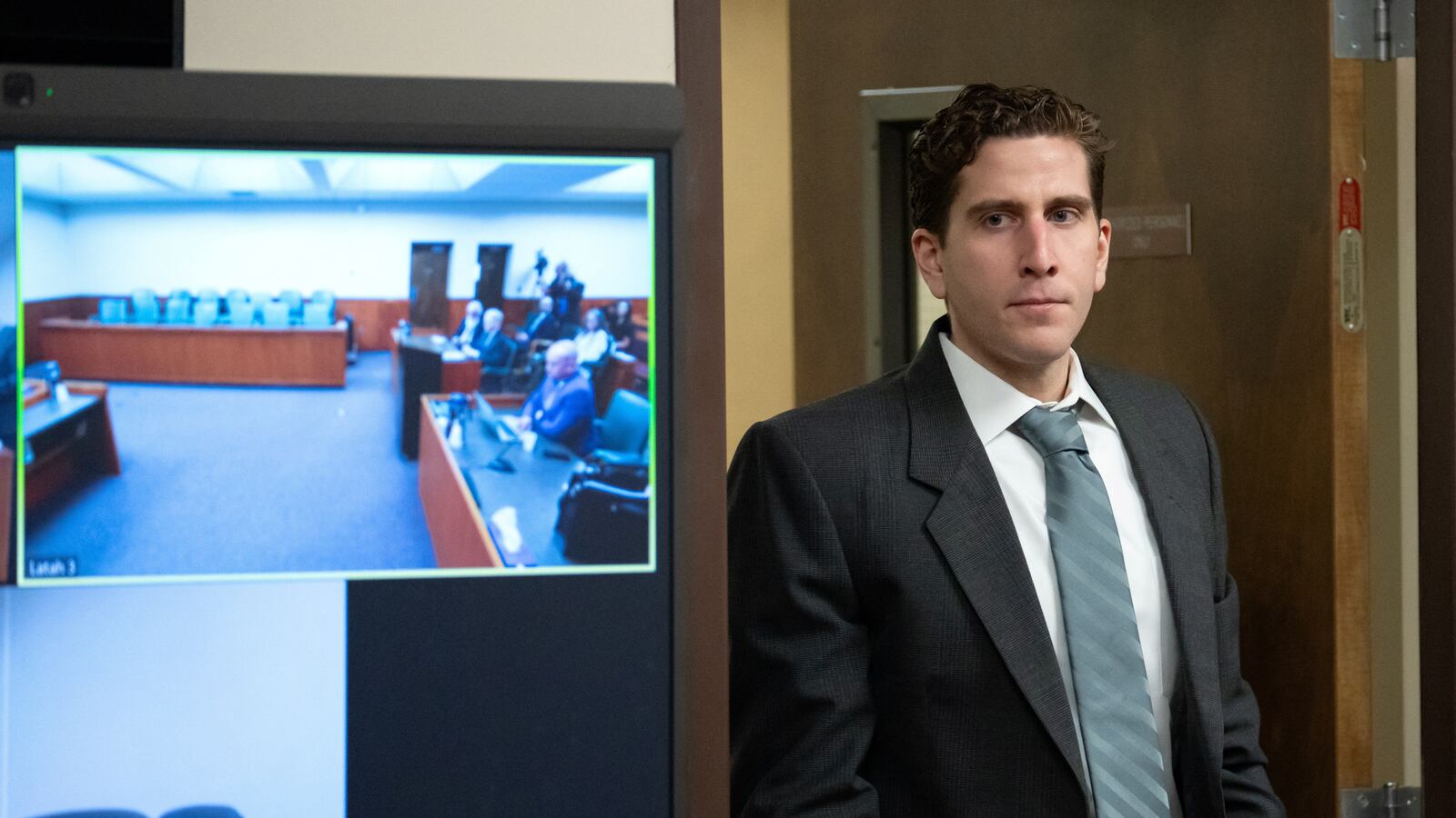 Bryan Kohberger, who is accused of killing four University of Idaho students in November 2022, walks past a video display as he enters a courtroom to appear at a hearing in Latah County District Court.