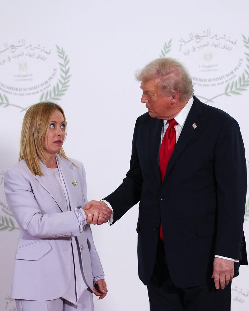 President Donald Trump and Italian Prime Minister Giorgia Meloni shake hands as they pose for a photo during a world leaders' summit on October 13, 2025 in Sharm El-Sheikh, Egypt.
