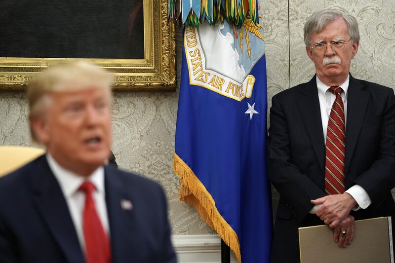 WASHINGTON, DC - JULY 18: White House National Security Advisor John Bolton (R) listens to U.S. President Donald Trump as he and Dutch Prime Minister Mark Rutte talk to reporters in the Oval Office at the White House July 18, 2019 in Washington, DC. According to the Dutch government, the two leaders will discuss defense and security cooperation, especially focused on whether the Netherlands will participate in a global effort to secure international waterways against threats from Iran. (Photo by Chip Somodevilla/Getty Images)