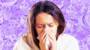 A photo illustration of a sick woman blowing her nose.