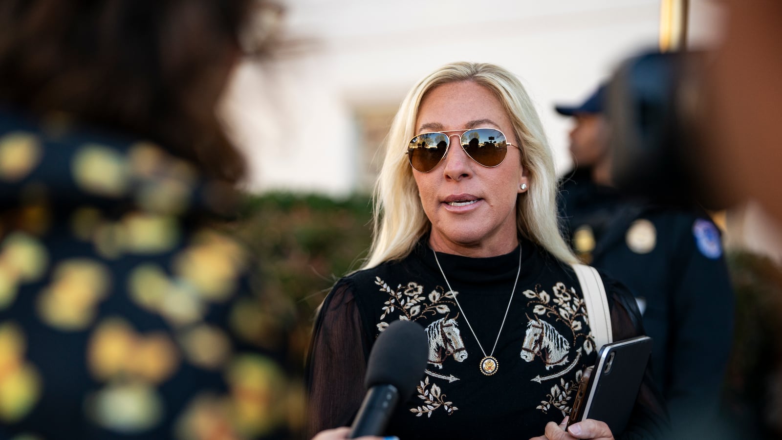 WASHINGTON, DC - MARCH 25: Rep. Marjorie Taylor Greene (R-Ga.) speaks to reporters while arriving at the Capitol Hill Club for a meeting of the House Republican Conference on March 25, 2025 in Washington, DC. Republicans are meeting as the Trump administration faces blowback after defense plans were posted to a group chat that accidentally included a prominent journalist. (Photo by Al Drago/Getty Images)