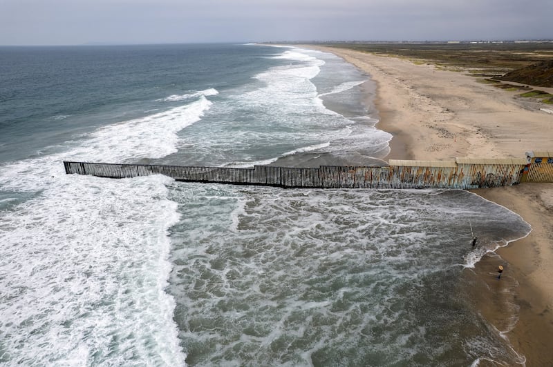 An aerial view shows the Mexico-U.S. border wall extending into the Pacific Ocean near Tijuana, Mexico
