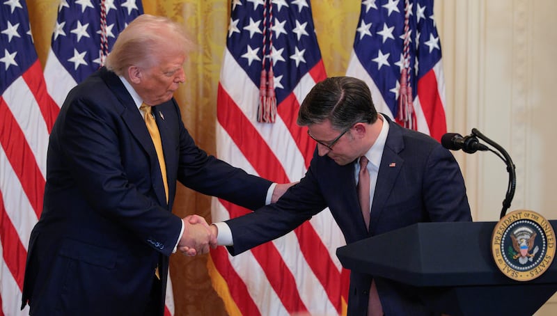 President Donald Trump and House Speaker Mike Johnson shake hands at a reception for Republican members of the House of Representatives in the East Room of the White House on July 22, 2025 in Washington, DC.