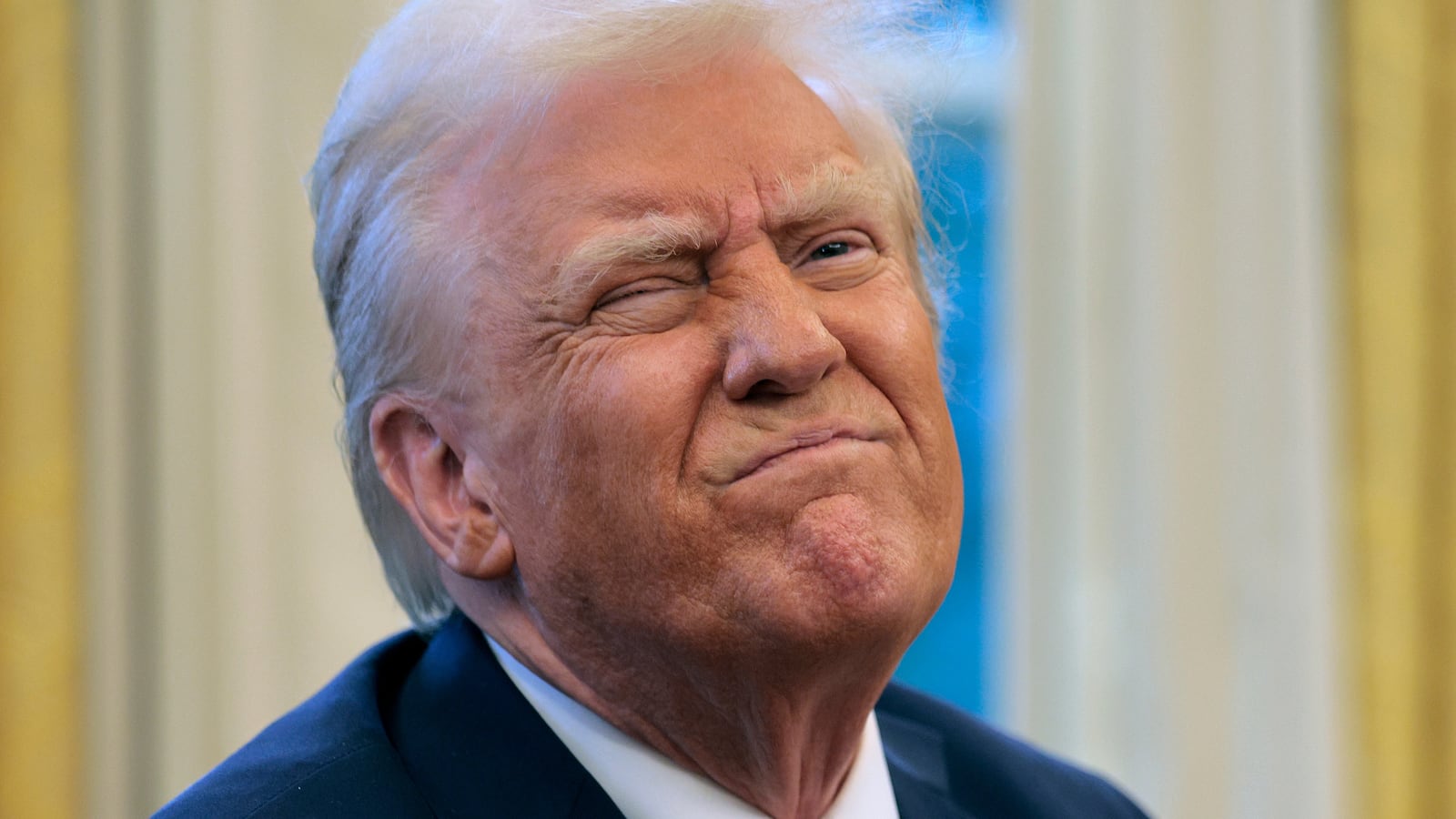 President Donald Trump reacts to a reporter's question from the Resolute Desk after signing an executive order to appoint the deputy administrator of the Federal Aviation Administration in the Oval Office at the White House on January 30, 2025 in Washington, DC.