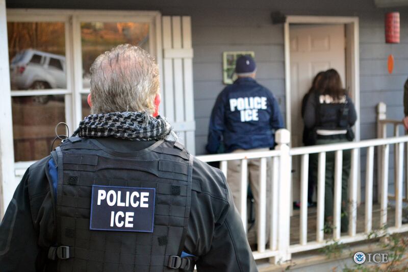 Immigration and Customs Enforcement agents outside a home in Atlanta, Georgia.