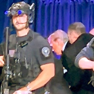 U.S. President Donald Trump is escorted out after a man opened fire with a shotgun on security personnel outside the room, during the annual White House Correspondents' Association dinner in Washington, D.C., U.S., April 25, 2026, in this still image from video.