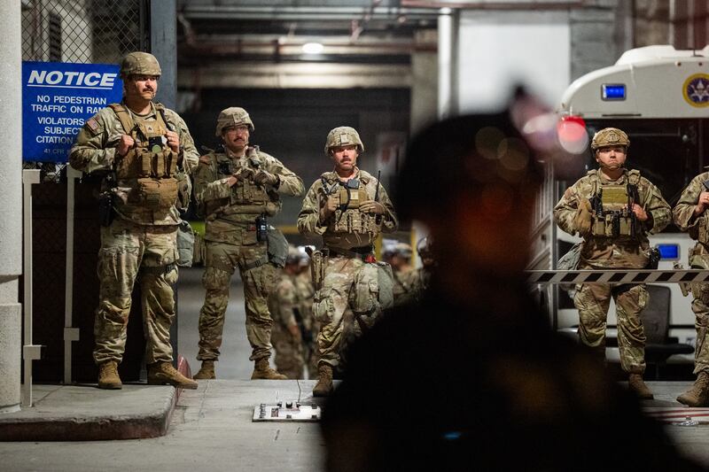 National Guard soldiers stand on duty in front of the federal Metropolitan Detention Center on July 26, 2025 in Los Angeles after President Trump first ordered the deployment of troops to the city.