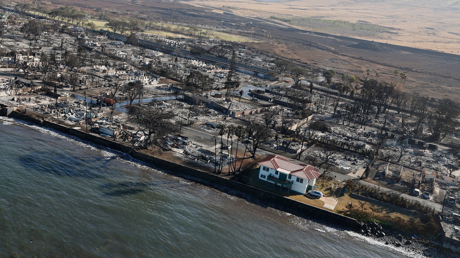 A single house on Front St. looks unscathed by the devastating wildfire that swept through Lahaina, Maui, Hawaii.