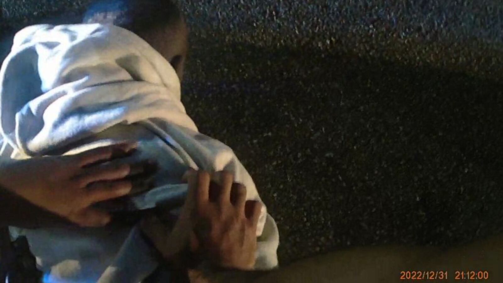 A screenshot from the body-cam footage showing officers pinning down Keith Murriel.