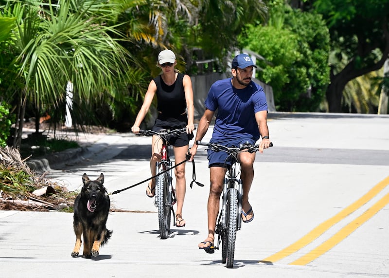 SURFSIDE, FL - JULY 14: Joaquim Valente and Gisele Bündchen are seen on a bike ride on July 14, 2024 in Surfside, Florida. (Photo by MEGA/GC Images)