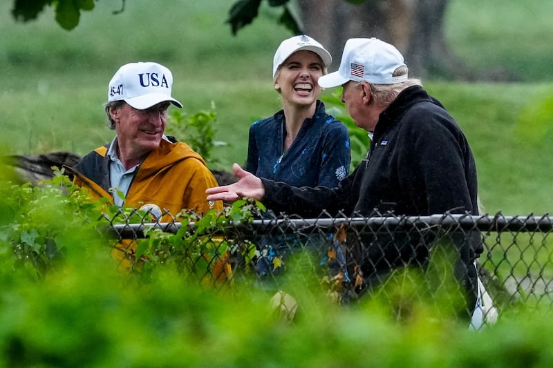 U.S. Interior Secretary Doug Burgum and Executive assistant to U.S. President Donald Trump Natalie Harp speak with Donald Trump during a visit at a golf course at Hains Point in Washington, D.C., U.S., June 28, 2026. REUTERS/Ken Cedeno     TPX IMAGES OF THE DAY