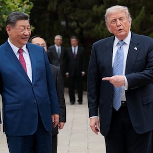 U.S. President Donald Trump gestures towards Chinese President Xi Jinping while leaving after a visit to the Zhongnanhai Garden in Beijing, China,