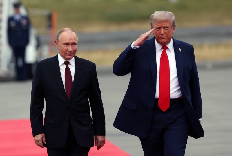 ANCHORAGE, ALASKA - AUGUST 15: (RUSSIA OUT) U.S. President Donald Trump welcomes Russian President Vladimir Putin to Joint Base Elmendorf-Richardson on August 15, 2025 in Anchorage, Alaska. The two leaders are meeting for peace talks aimed at ending the war in Ukraine. (Photo by Contributor/Getty Images)