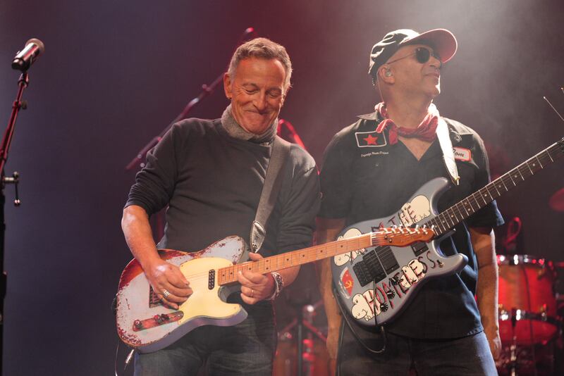 Bruce Springsteen and Tom Morello of Rage Against the Machine perform on stage holding guitars