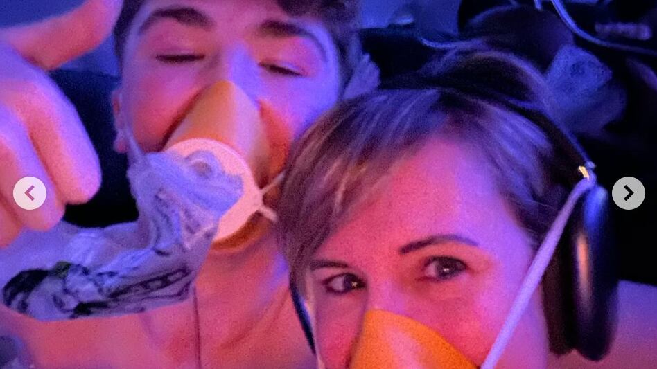 A selfie from Alaska Airlines flight 1282 of Kelly Bartlett and a teen named Jack. They are both wearing oxygen masks but appear to be smiling and in good spirits.