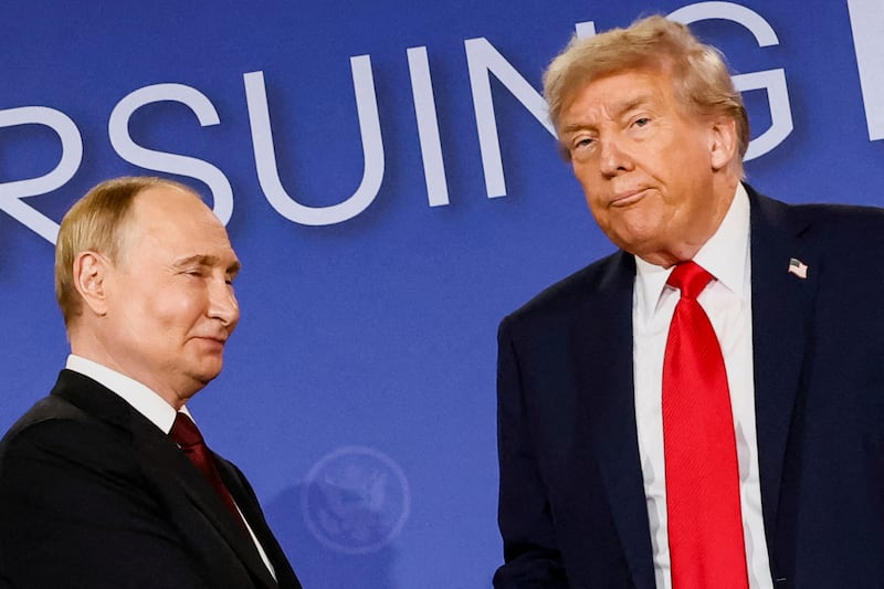 U.S. President Donald Trump looks on next to Russian President Vladimir Putin during a press conference following their meeting to negotiate an end to the war in Ukraine.