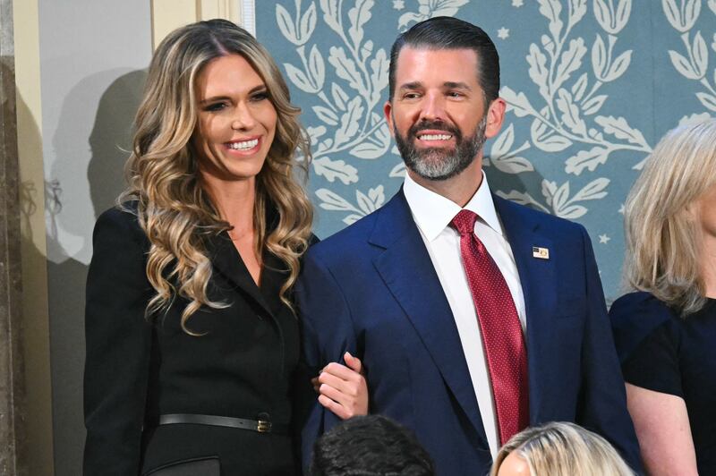 Donald Trump Jr. (R) arrives with Bettina Anderson ahead of US President Donald Trump's address to a joint session of Congress in the House Chamber of the US Capitol in Washington, DC, on March 4, 2025.