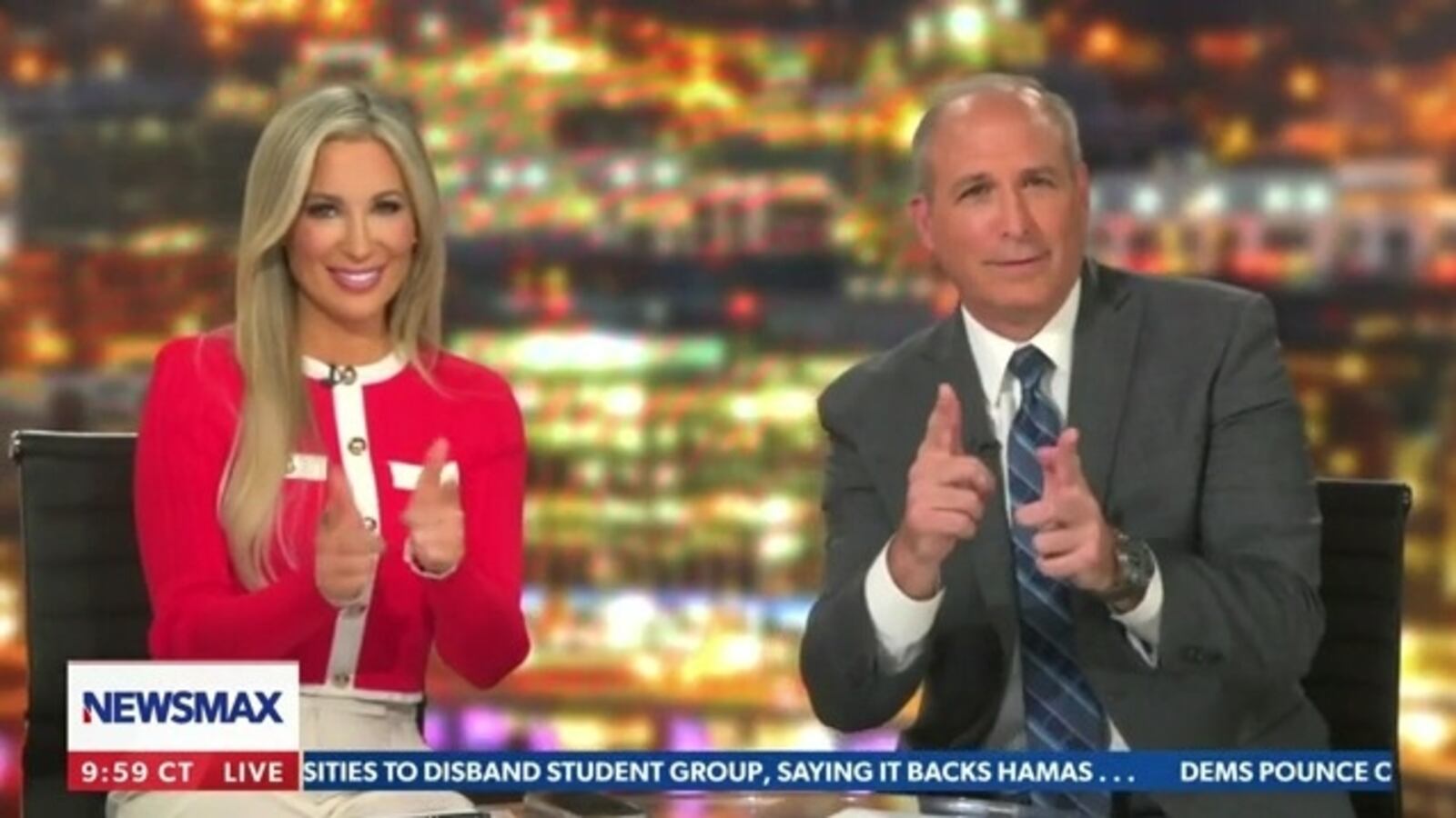 Newsmax panelists Jenn Pellegrino and Mark Morgan pretend to shoot during broadcast of The Right Squad.