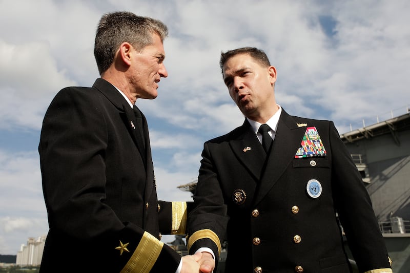 Rear Adm. Marc Dalton(L), the Commander of US aircraft carrier Ronald Reagan and Brad Cooper(R),