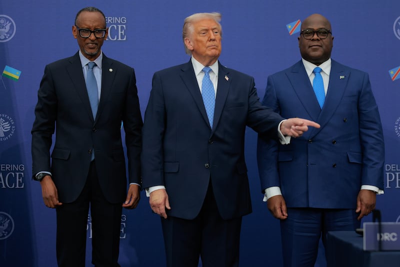 President Donald Trump (C) poses for photographs with Rwandan President Paul Kagame (L) and Democratic Republic of Congo President Felix Tshisekedi after signing a peace accord at the Donald J. Trump Institute of Peace on December 04, 2025 in Washington, DC.