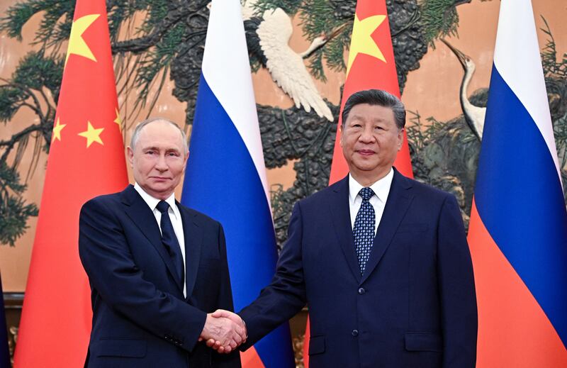 In this pool photograph distributed by the Russian state agency Sputnik, Russia's President Vladimir Putin (L) shakes hands with China's President Xi Jinping during a meeting at The Great Hall of the People in Beijing on September 2, 2025. (Photo by Sergey Bobylev / POOL / AFP) (Photo by SERGEY BOBYLEV/POOL/AFP via Getty Images)